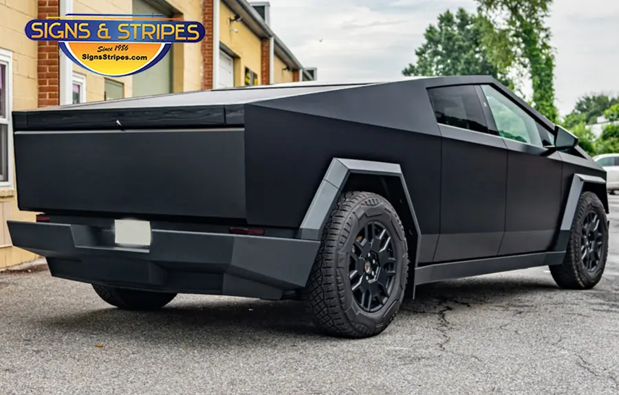 Matte black Cybertruck wrap, rear three-quarter view